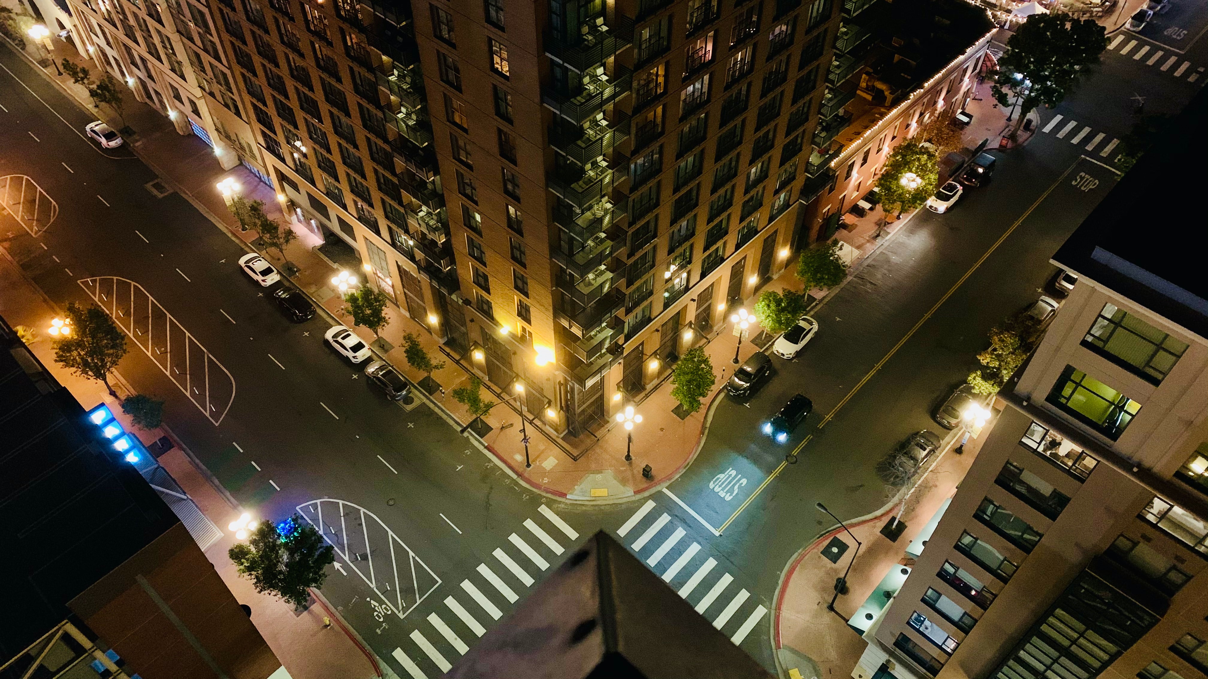 Overhead picture of two urban streets converging at an intersection at night in downtown San Diego